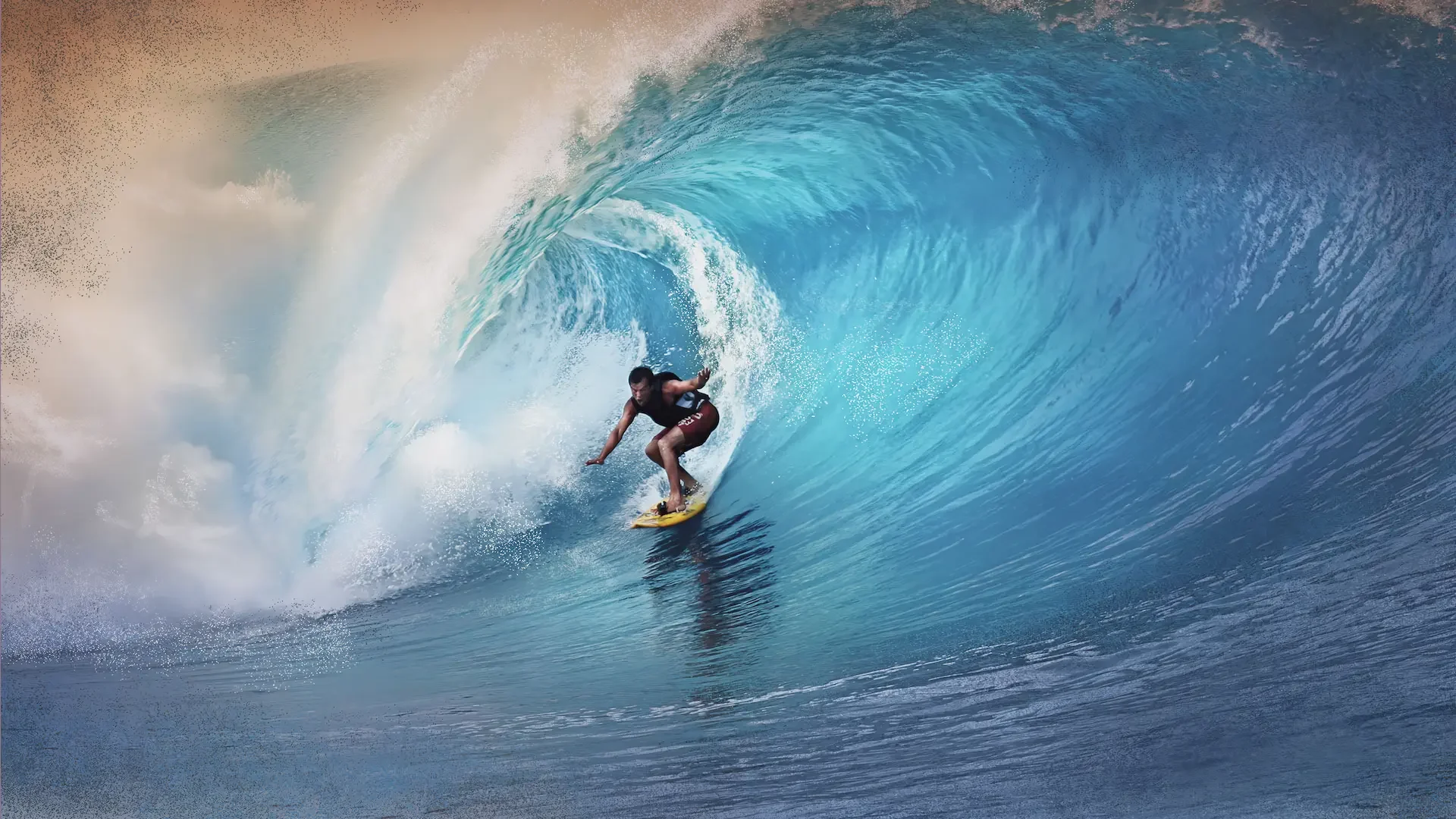 A male surfer expertly riding inside a large, blue wave during a surfing session in Sanur, Bali